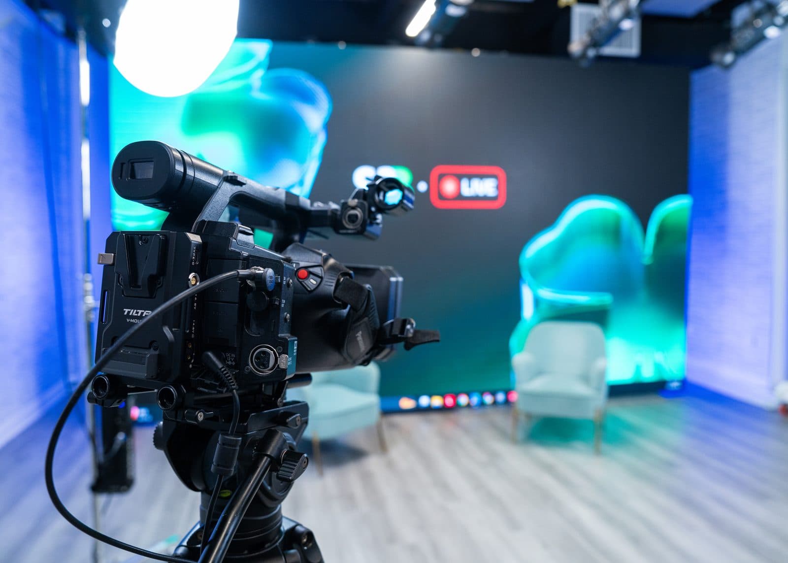 A broadcast camera framed on the LED wall in the AVP.Live studio in Freehold, New Jersey, lit for a live-to-tape record